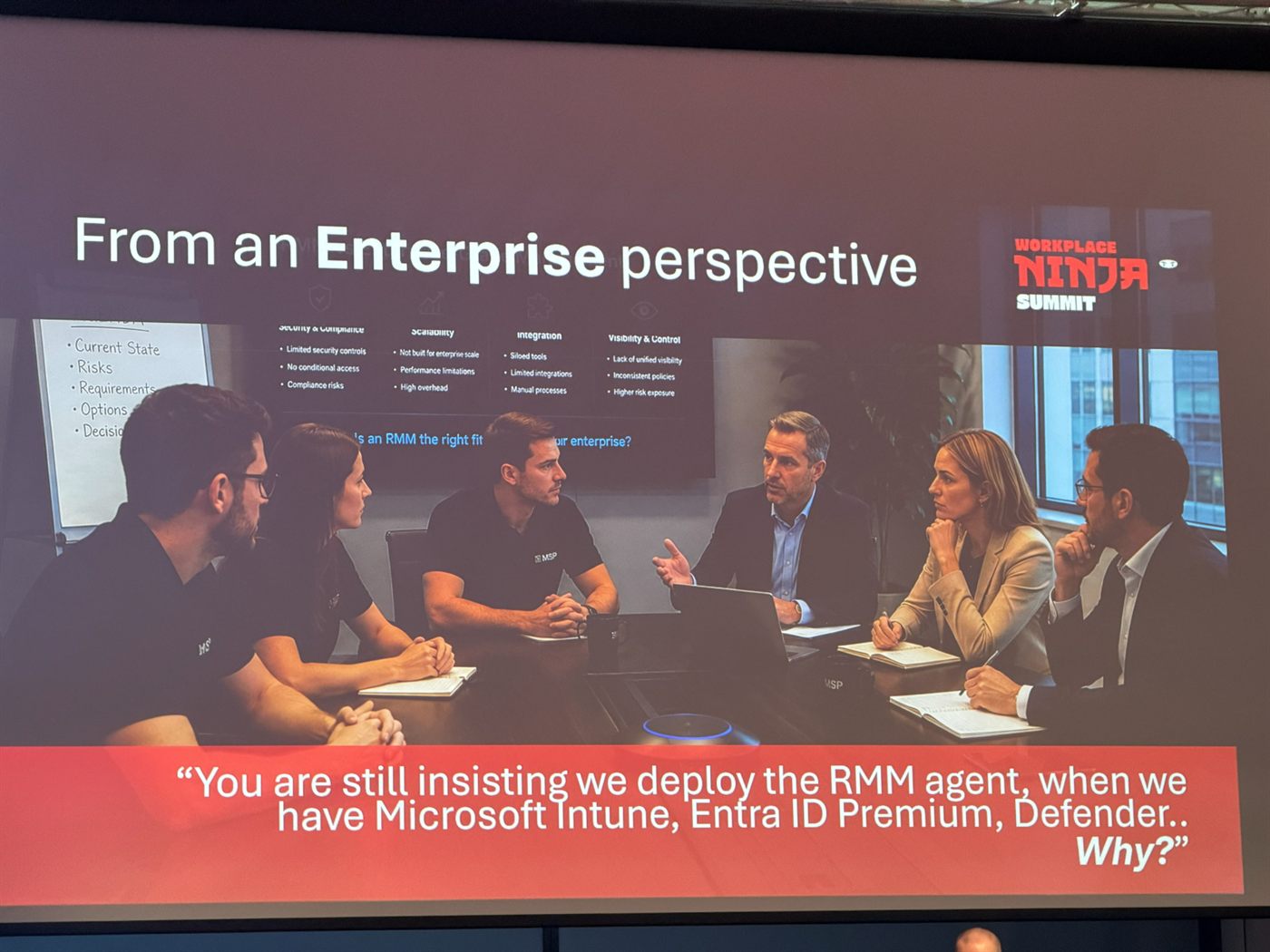 Slide titled "From an Enterprise perspective" showing a meeting room, with the quote "You are still insisting we deploy the RMM agent, when we have Microsoft Intune, Entra ID Premium, Defender.. Why?"